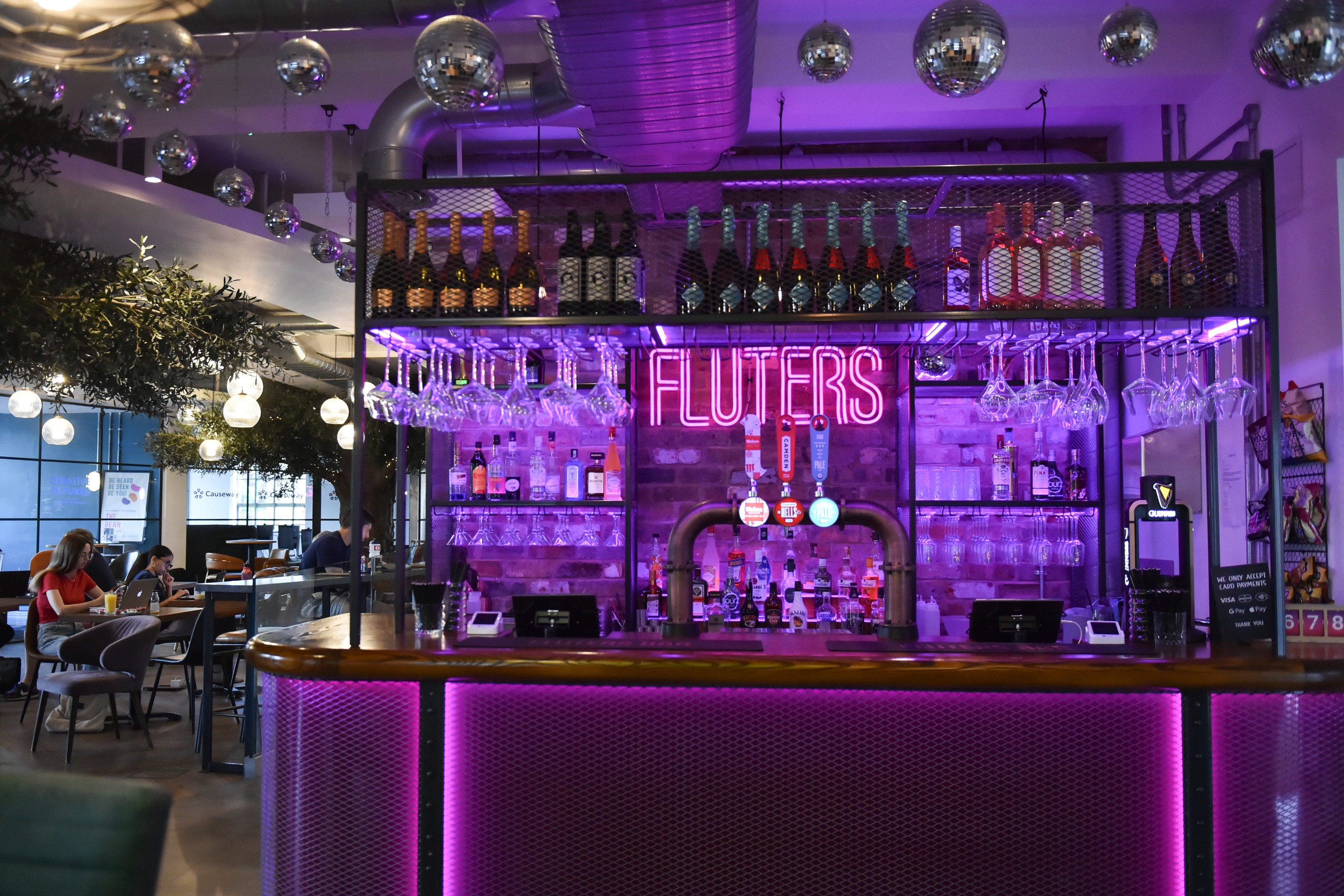 neon sign and lighting over a bar area