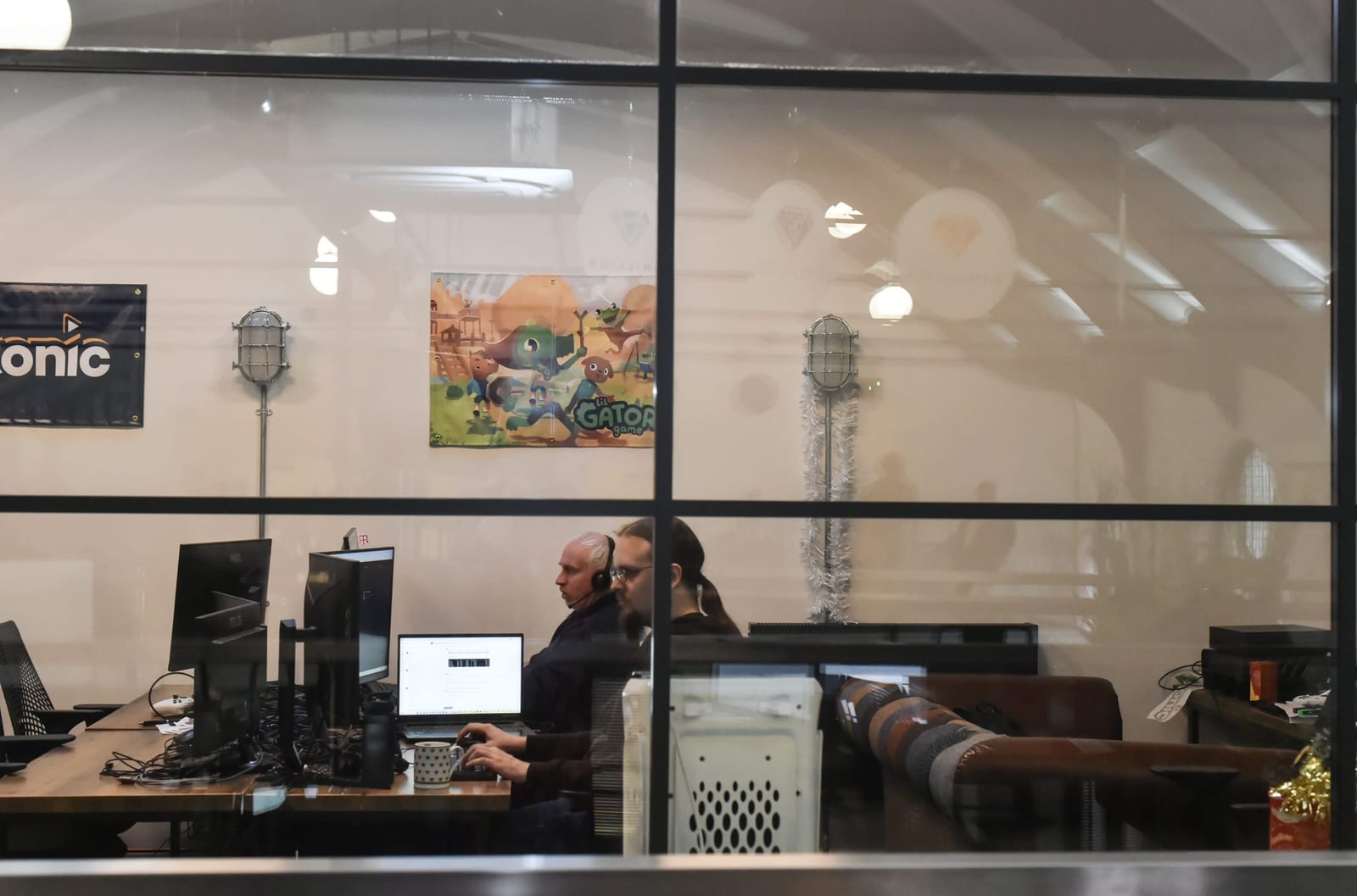 A team working at their desks inside a glass-walled office at 1 Mill Street