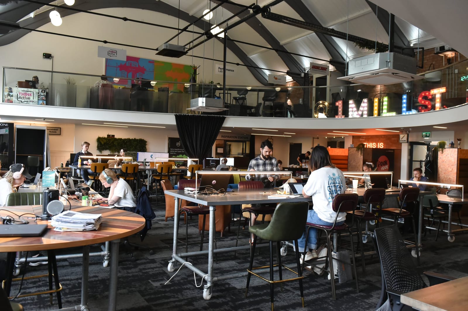 The upstairs coworking floor at 1 Mill Street, Leamington Spa, with members working at long shared desks
