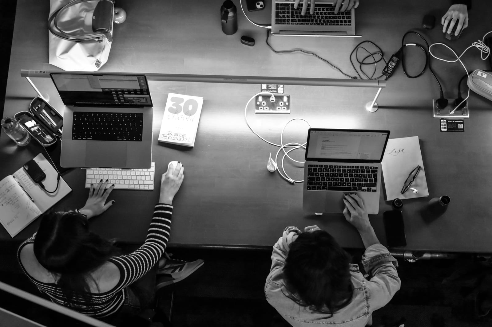 Black and white overhead view of members working side by side