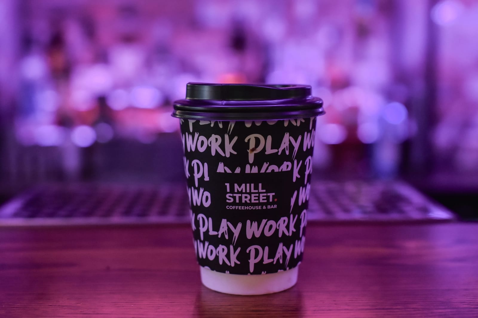 A Work Play cup on a desk at 1 Mill Street