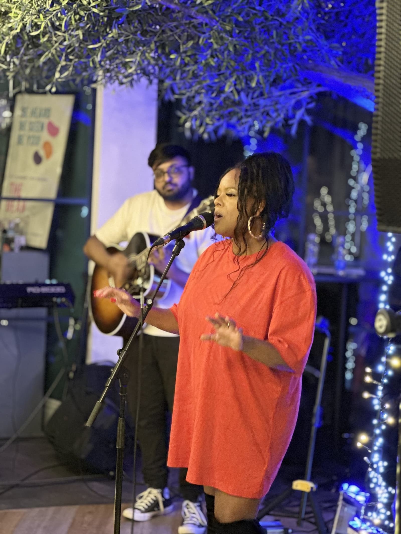 A singer performing live music at the bar