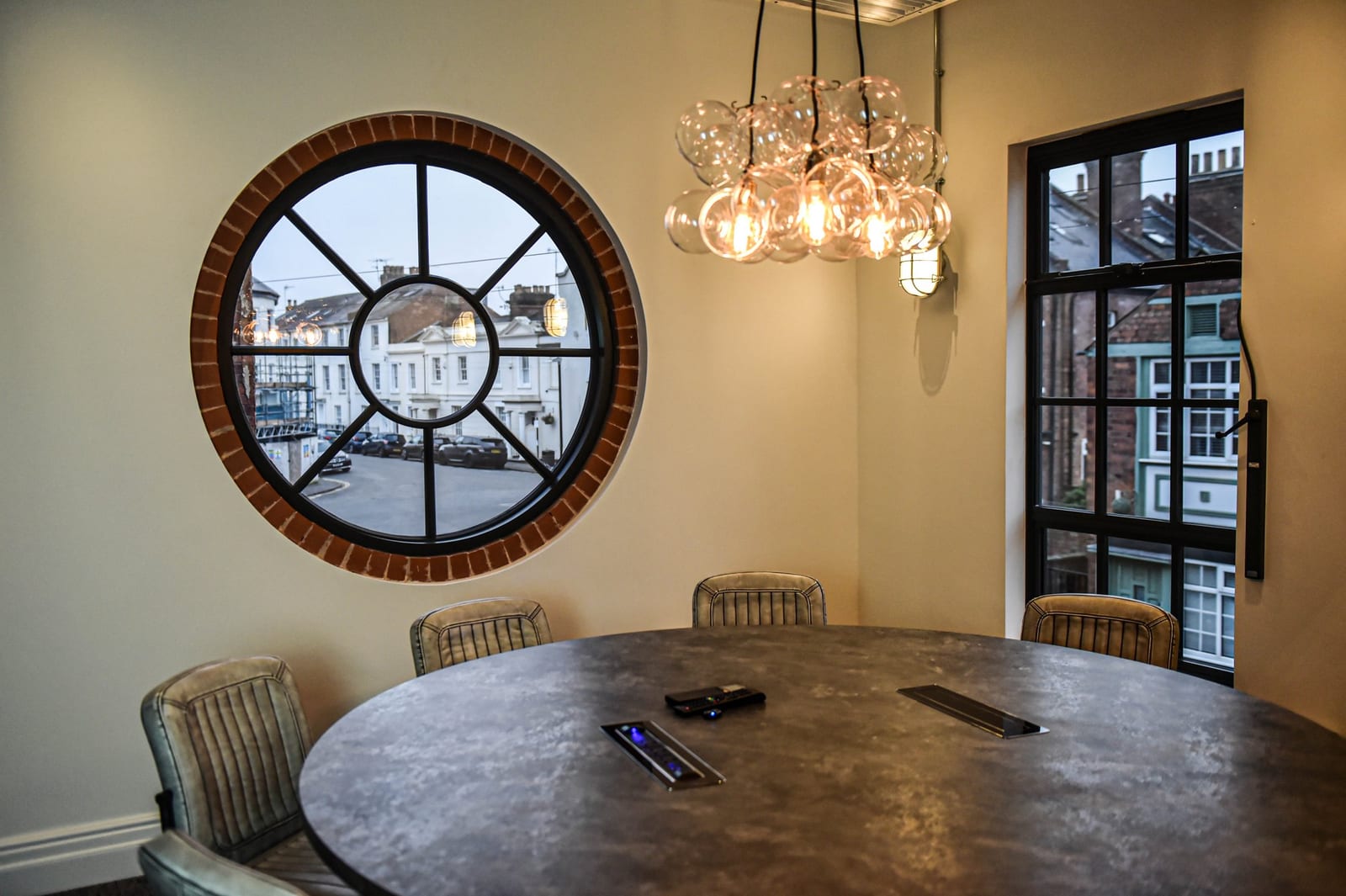 The First Floor meeting room at 1 Mill Street with a round table and big windows