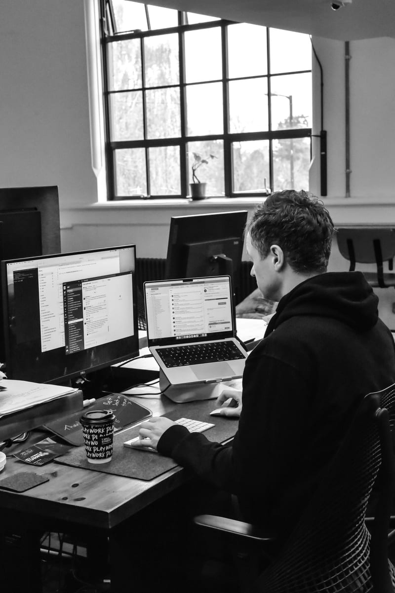 A developer working across two screens