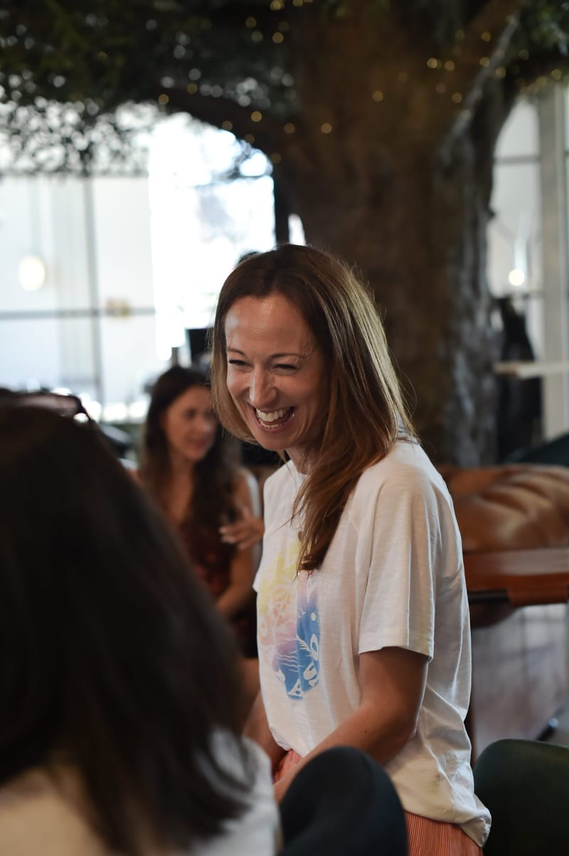 A member laughing with friends in the coworking space